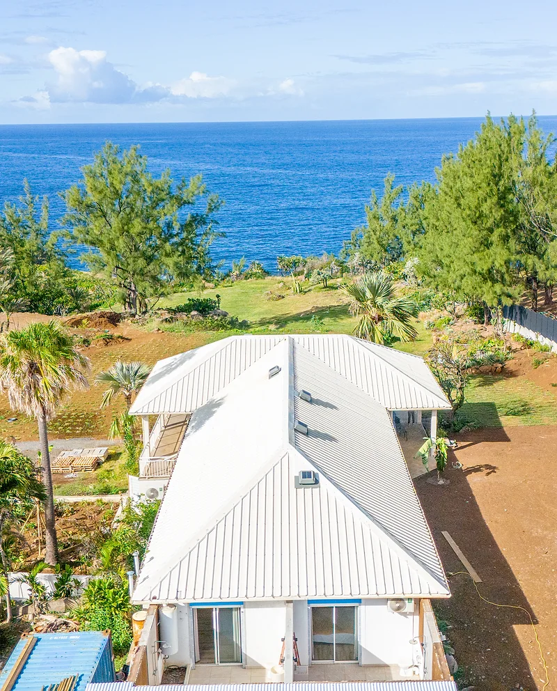 La villa vue d'en haut, la pelouse et l'océan derrière